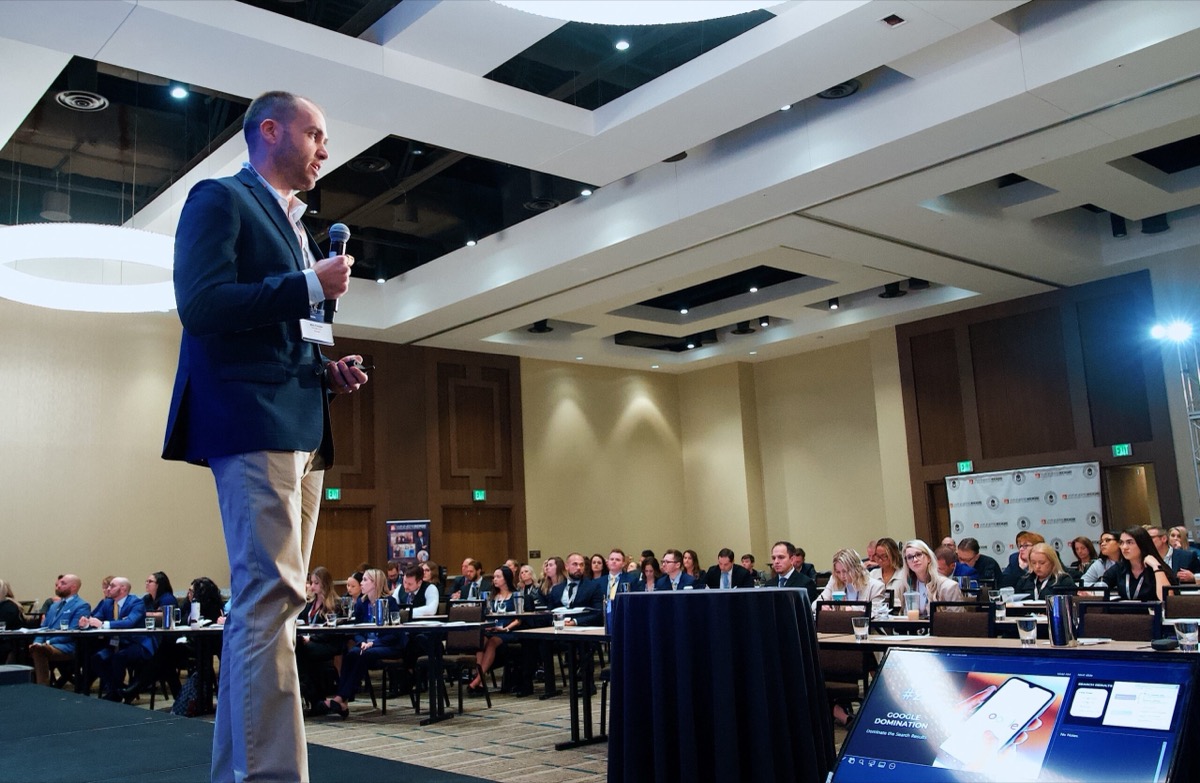 Nick Fischer, founder of CHIROBASIX, speaking at a chiropractic marketing event.